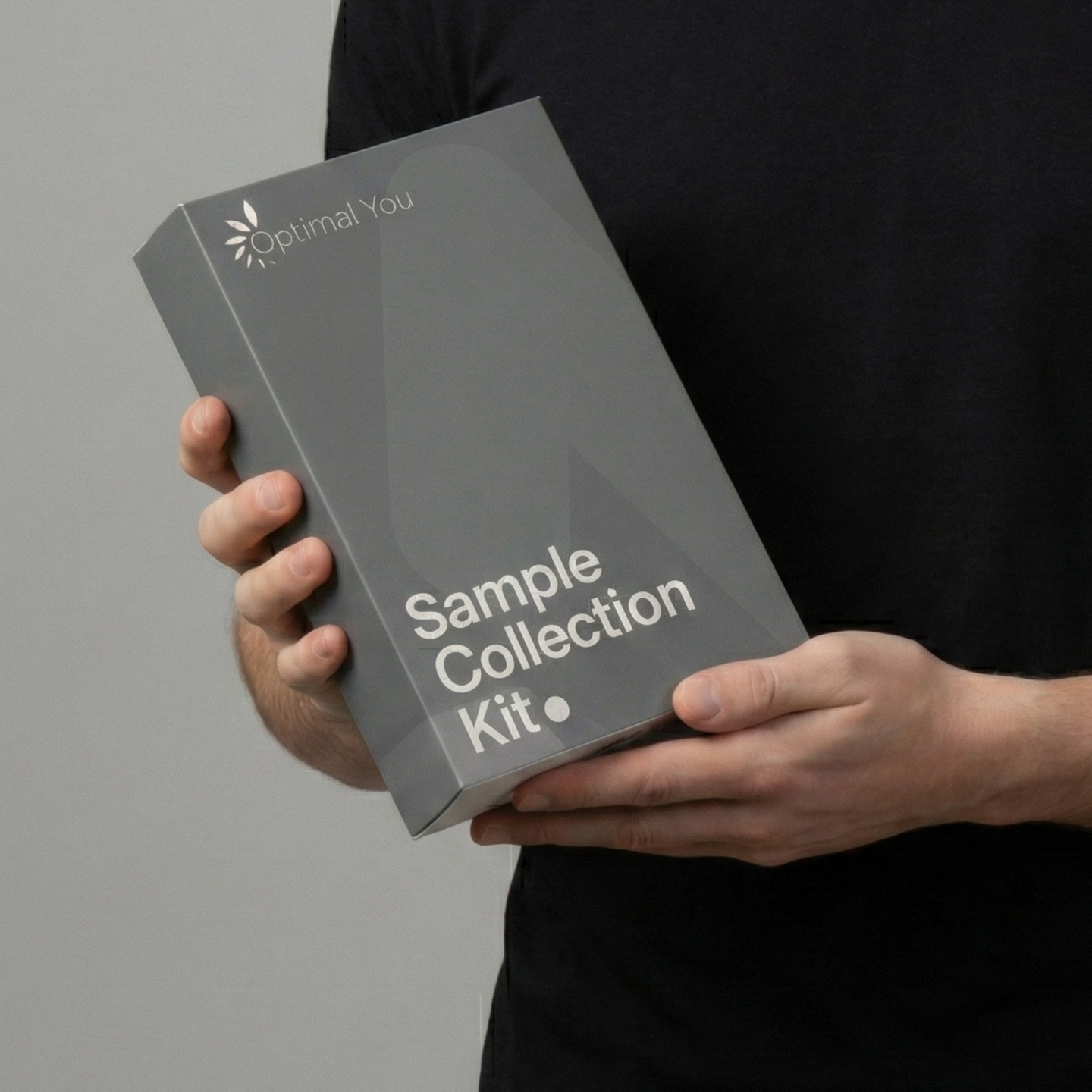 Person holding a 'Sample Collection Kit' from Optimal You against a grey background
