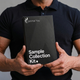 Person holding a 'Sample Collection Kit' from Optimal You against a neutral background