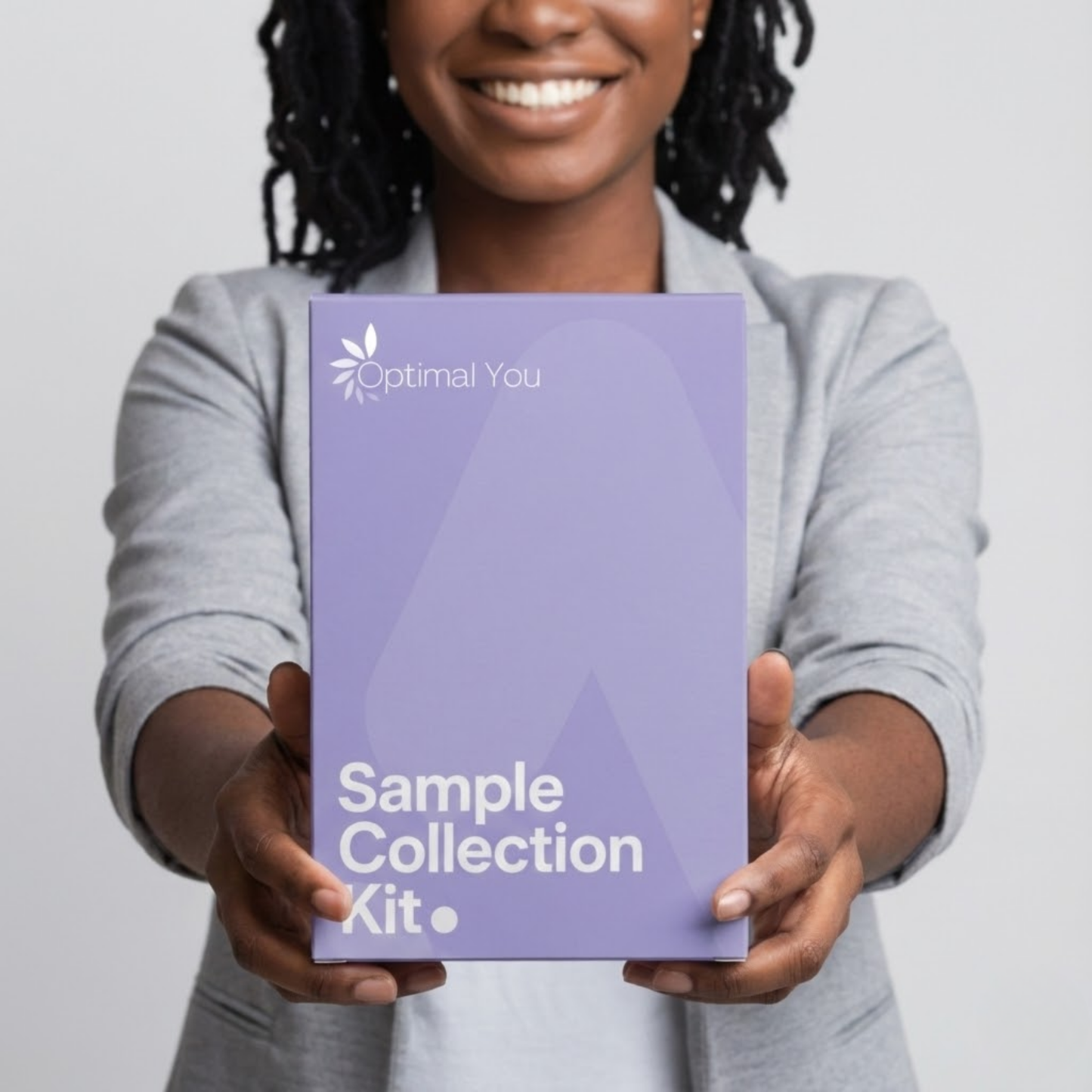 Person holding a purple 'Optimal You Sample Collection Kit' against a plain background